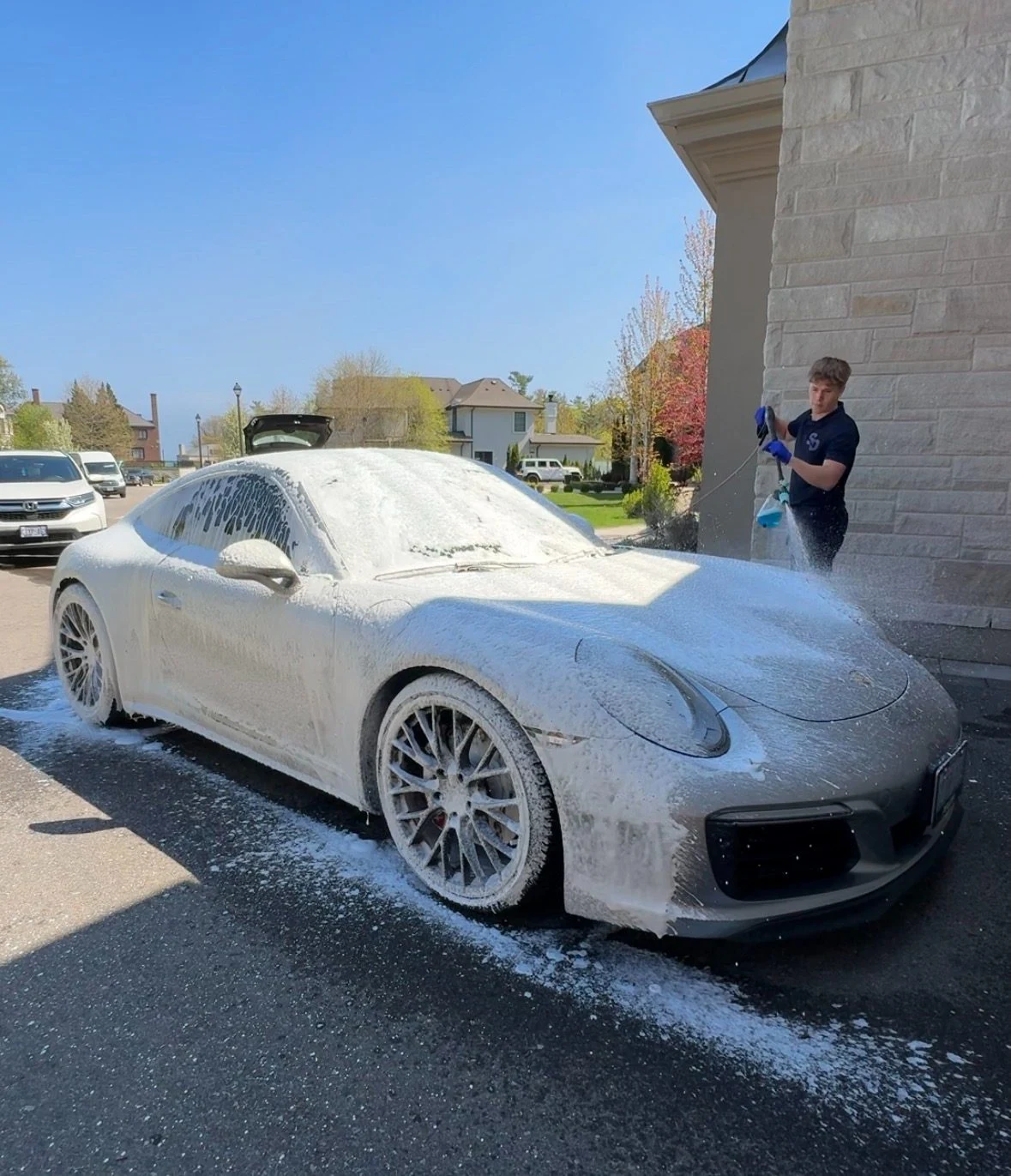 A Porsche being hand washed by SimplyDriven at a customer's home